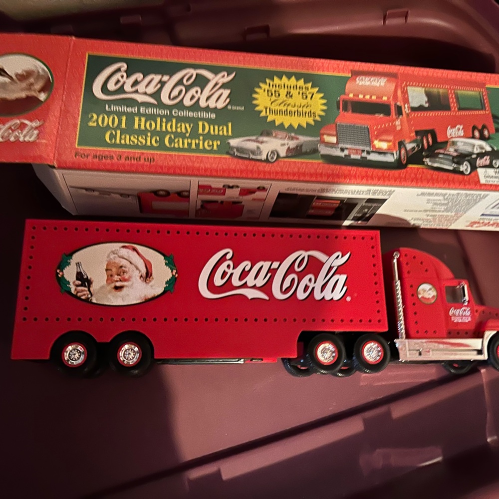 NIB year 2001 collectible Christmas hauler truck with two mini cars inside.